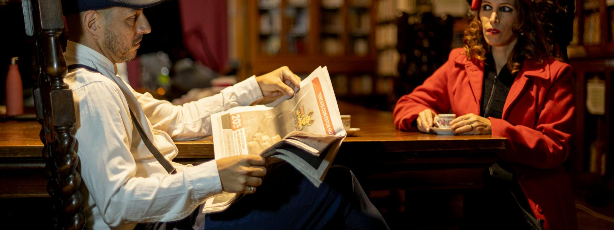 Elegant couple in vintage attire reading in a Buenos Aires library.
